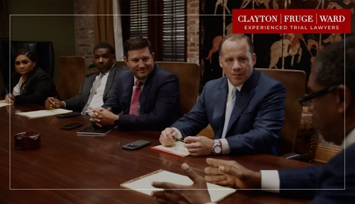 attorneys sitting at table with logo on picture
